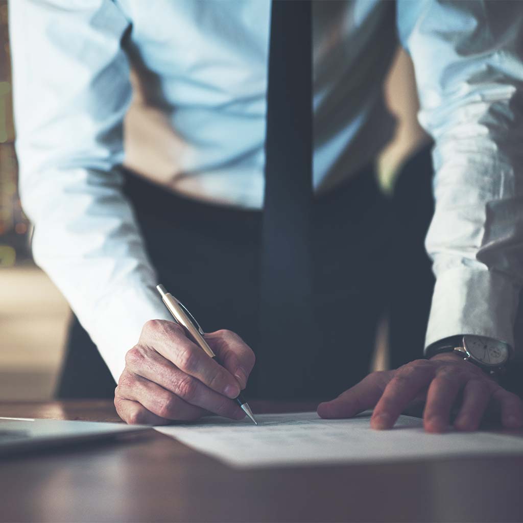 Close up business man signing contract