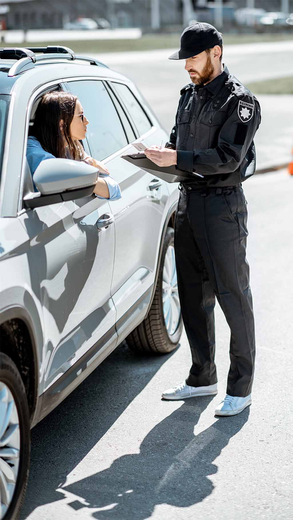 woman receiving a traffic ticket